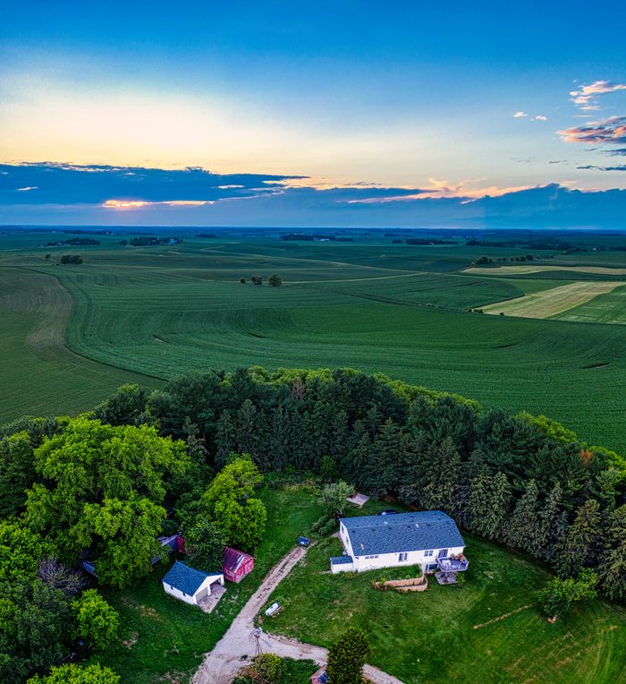 services-04 Stunning aerial view of a countryside estate surrounded by lush farmland in Minnesota at sunset.